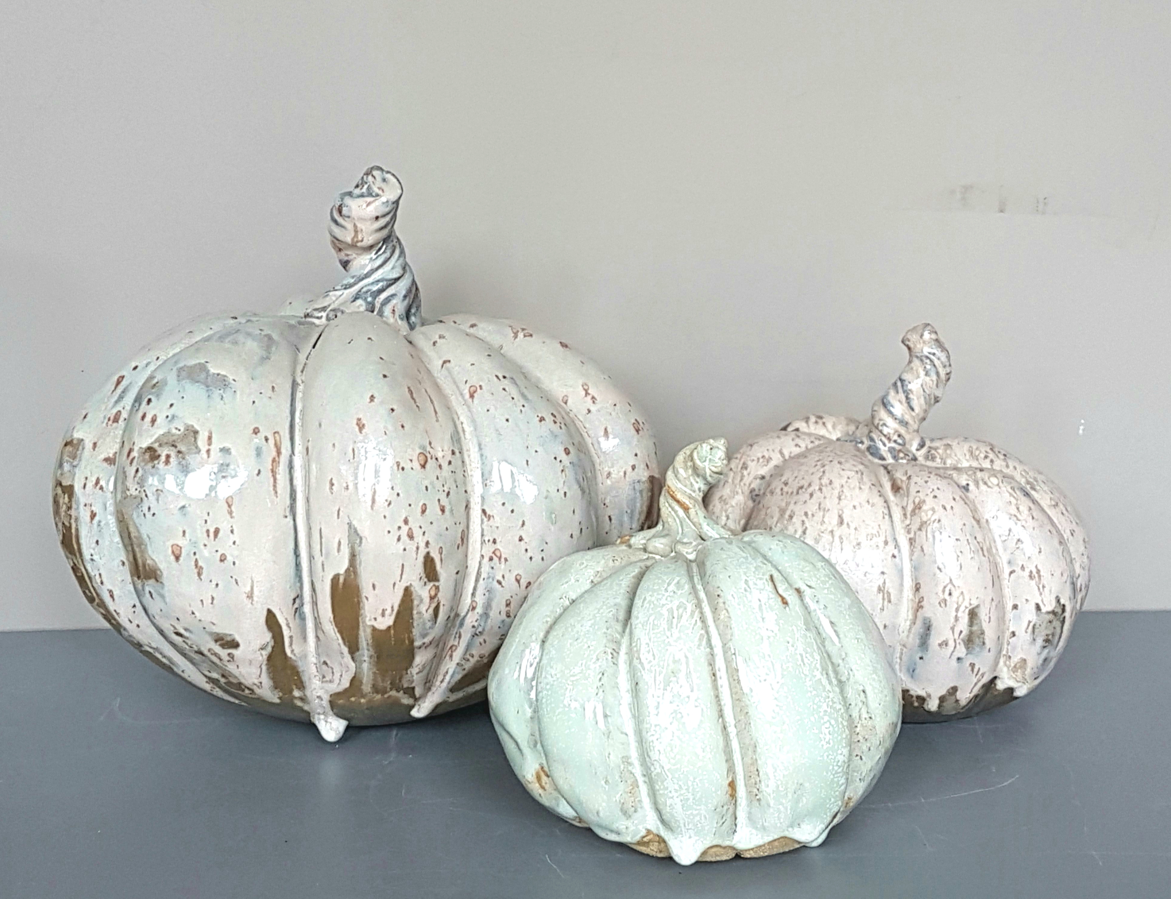 Three ceramic pumpkins in white and grey.