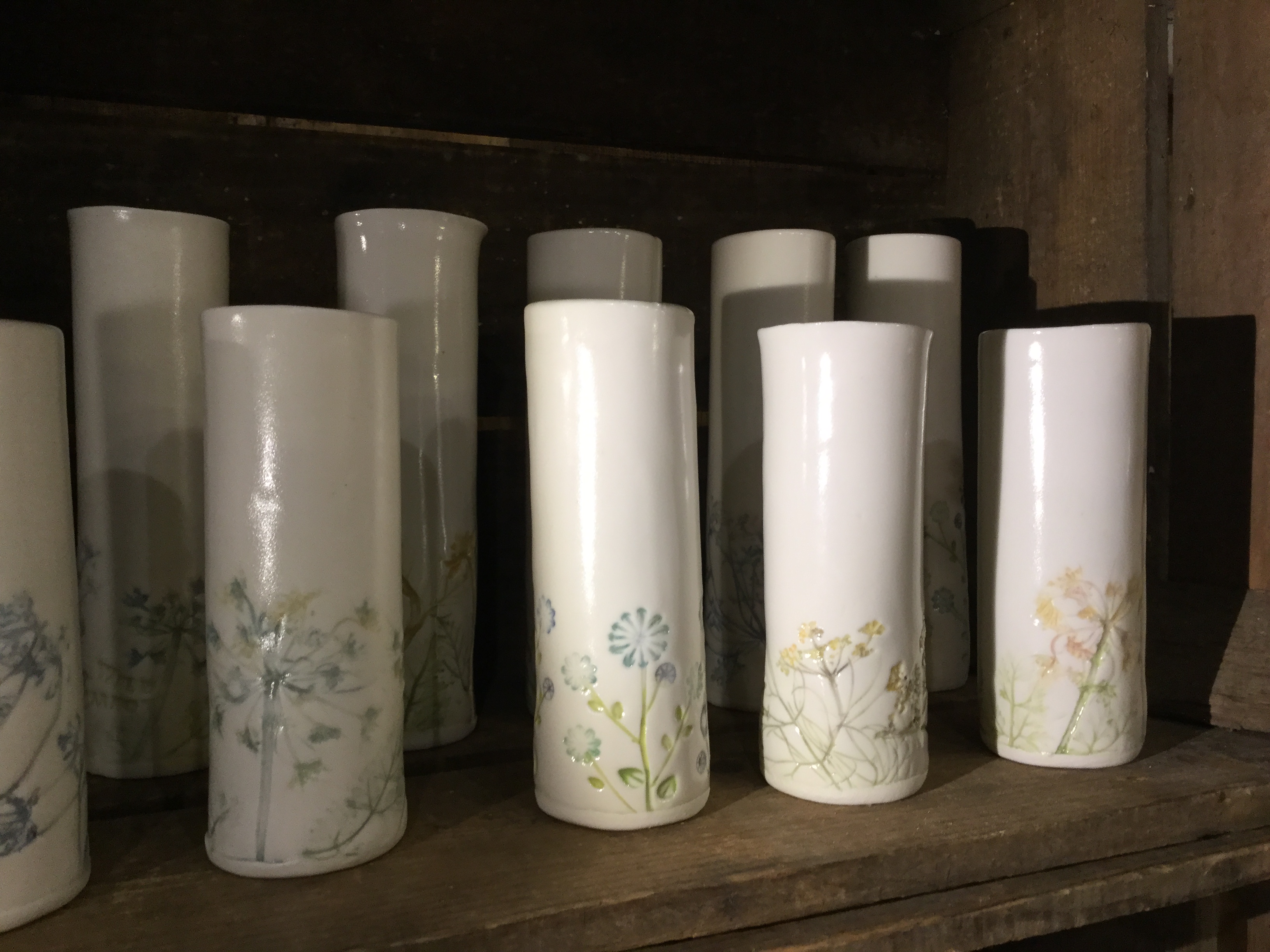 White ceramic vases with floral designs.