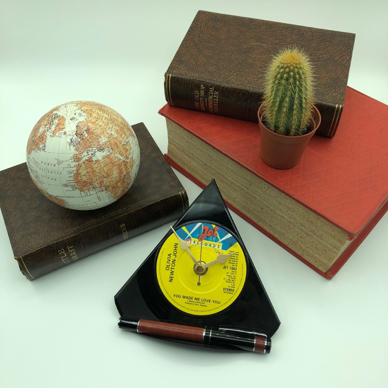 Vinyl record clock with globe and cactus.