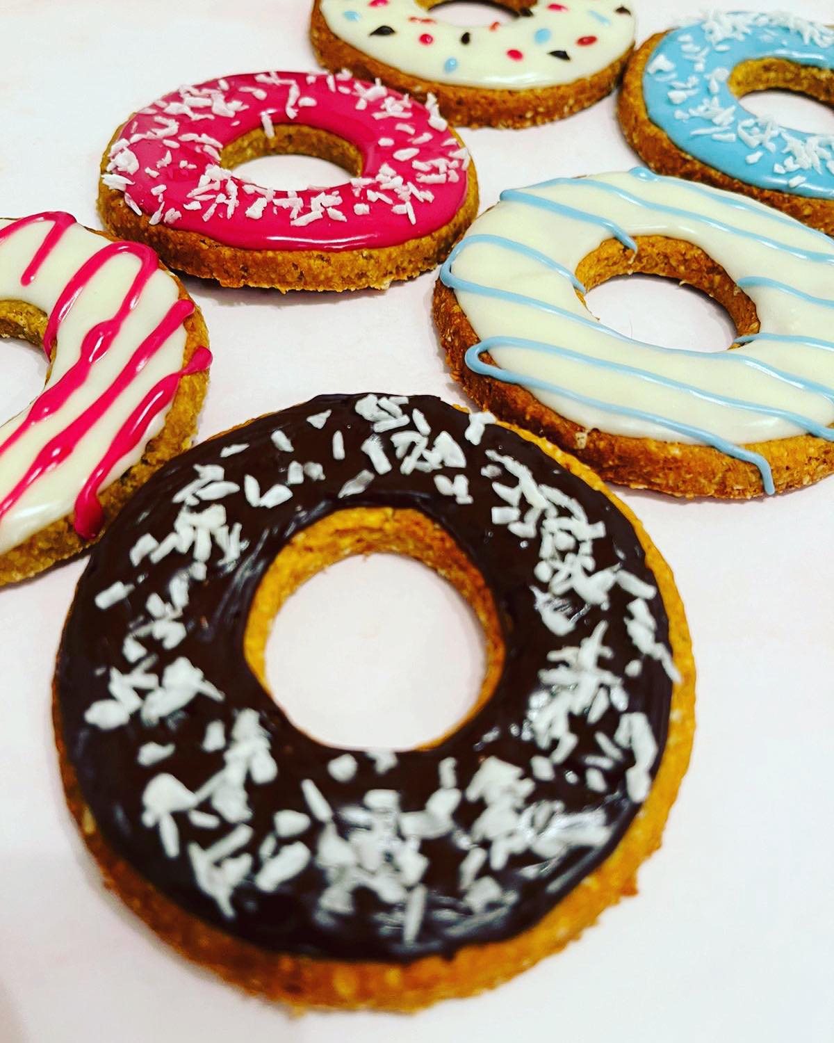 Assortment of colorful glazed donuts.