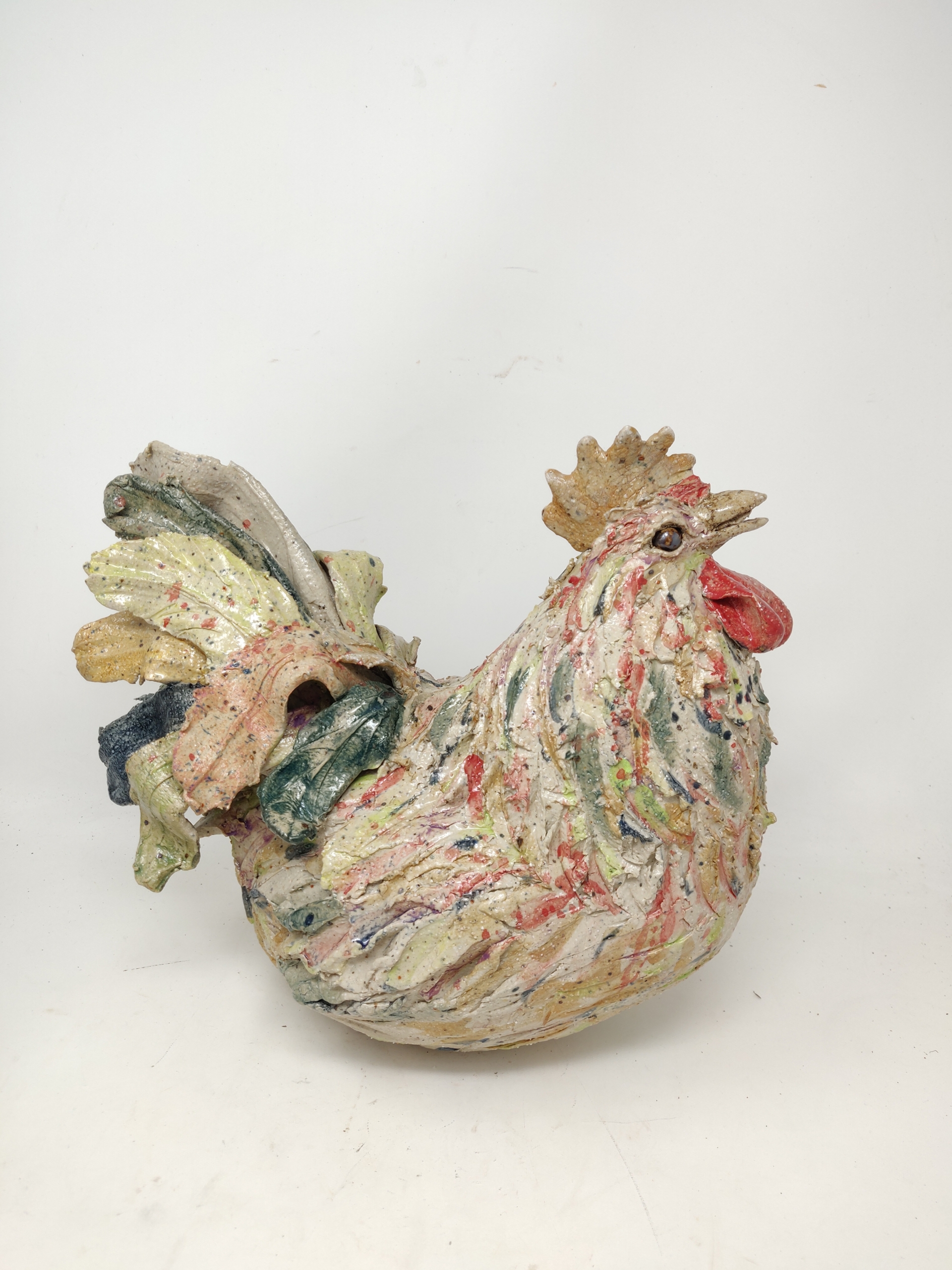 Ceramic rooster sculpture with colorful details.
