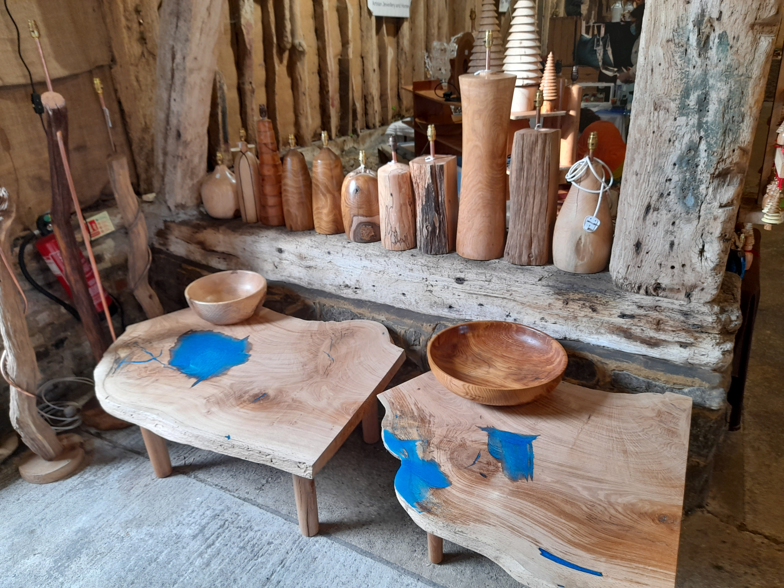 Wooden tables with blue resin inlays.