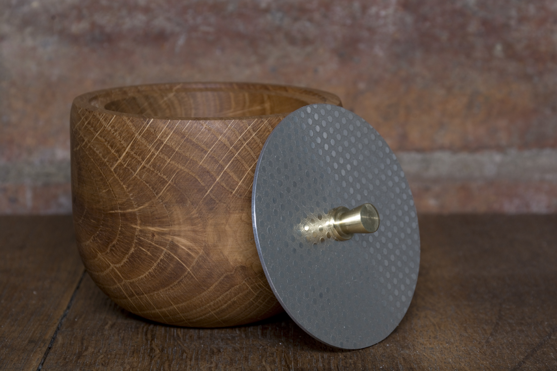 Wooden bowl with metal lid and knob.